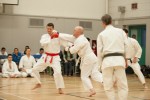 Kelly Williams (right, white) attacks Daniel Sibley (left, red) in the men's white belt division