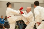 Dicken Poon (left, red) attcks Kelly Williams (right, white) in the men's white belt division